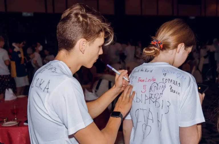 boy doing signatures on shirts