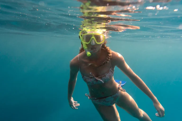Maldives Camp girl swimming in ocean with goggles
