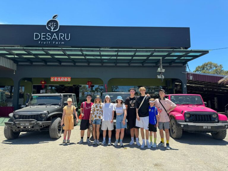 guys taking picture with cars -International Camps in Singapore for teens