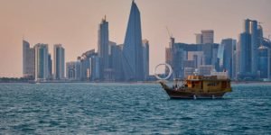 qatar Doha skyline in Doha, Qatar from the Corniche street afternoon shot with dhows in the Arabic gulfs in the foreground